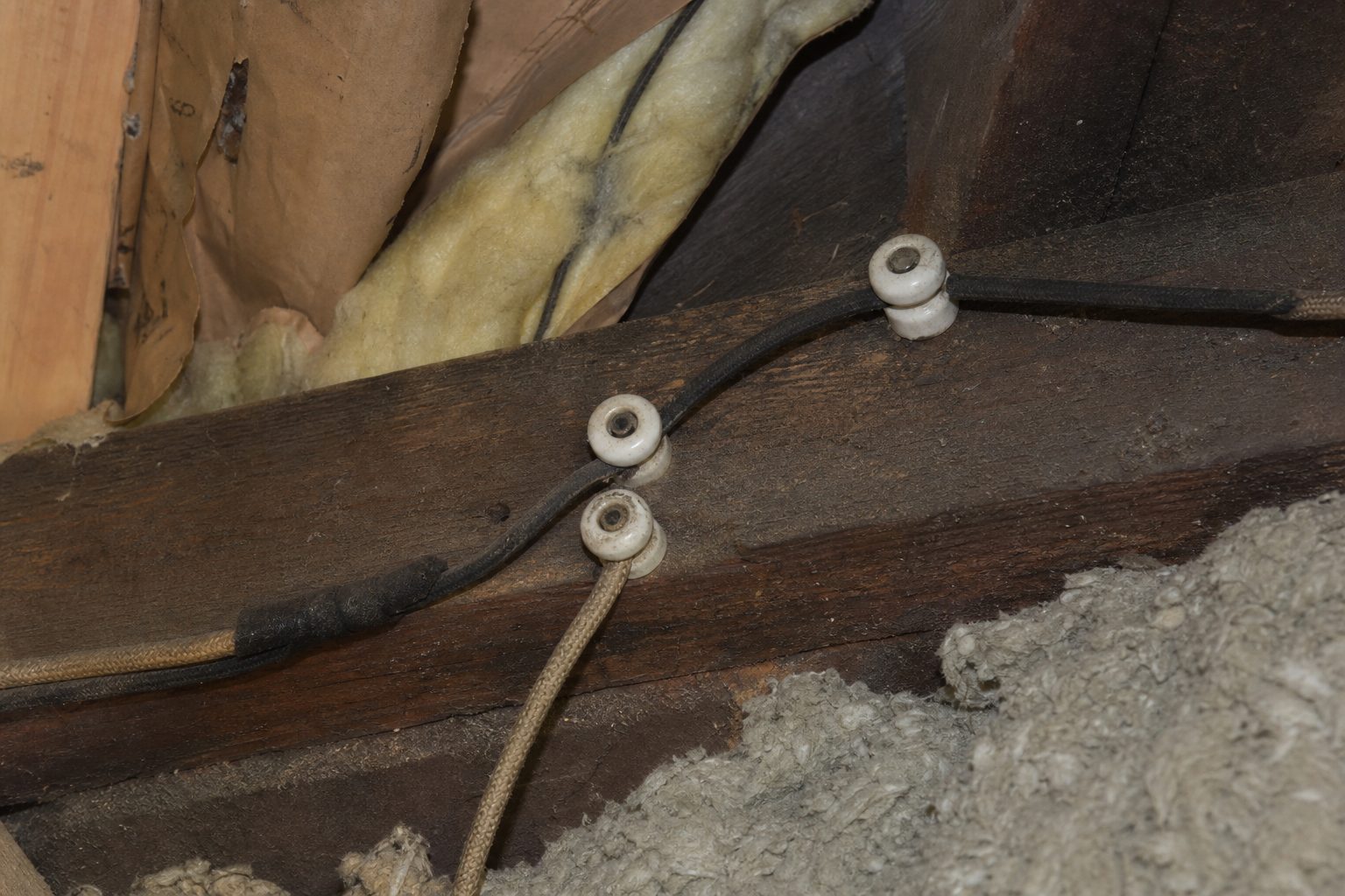 Vintage knob-and-tube wiring on ceramic knobs in a Winnipeg attic
